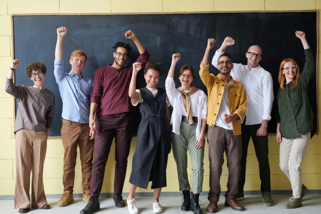 A group of people in front of a blackboard